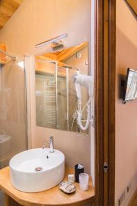 a bathroom with a sink and a mirror at LA PLACETTE - Albergo diffuso e Trattoria in Usseaux