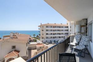 a balcony with chairs and a view of the ocean at Apartment Arce Frontline seaview in Nerja