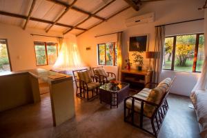 a living room with a couch and a table and chairs at Kaia Homestead in Sodwana Bay