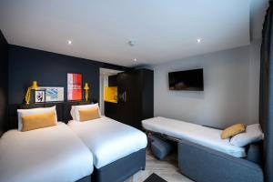 a hotel room with two beds and a television at Staycity Aparthotels Manchester Northern Quarter in Manchester