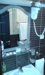 a bathroom with a mirror and a sink and a shower at Motel Park Rogatica in Rogatica