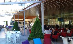 a group of people sitting in chairs in a restaurant at Motel Park Rogatica in Rogatica +22 photos