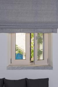 a window in a room with three windows at Akro Luxury Living in Astypalaia