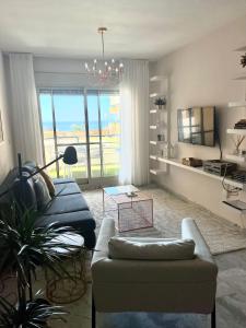 a living room with a blue couch and a table at Apartment Sea Breeze – Apartamento Brisas del Mar in Benalmádena