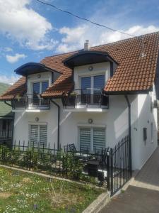 a white house with a red roof at BM Apartman in Zalakaros