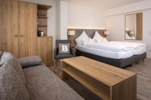a hotel room with a bed and a couch at cityhotel in Bocholt