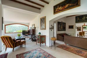 a living room filled with furniture and a large window at Domus Orestea Luxury Suites in Palermo