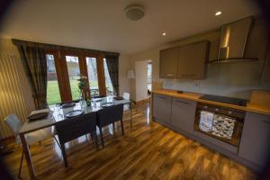 a kitchen with a table and a dining room at Crofts Mill in Ballater