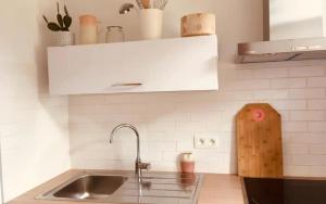 a kitchen with a sink and a counter top at A Côté, c'est aussi chez vous ! in Namur