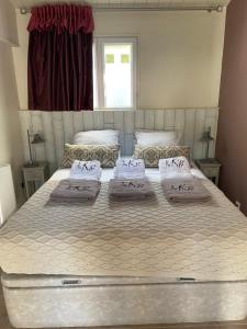 a large bed with three pillows on it in a bedroom at Au K'Ré in Rivedoux-Plage
