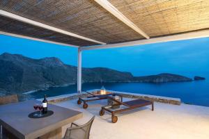 a patio with a table and a view of the ocean at Dreamy Cycladic Luxury Summer House 2 in Serifos Chora