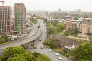 a highway in a city with cars on the road at Paradise Village Coventry in Coventry