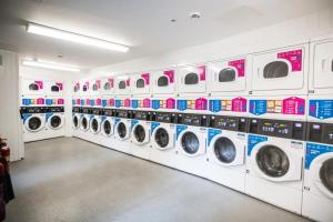 a row of washing machines in a laundrette at Paradise Village Coventry in Coventry