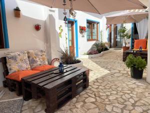 a patio with a couch and a coffee table at Canne al vento in Quartu SantʼElena