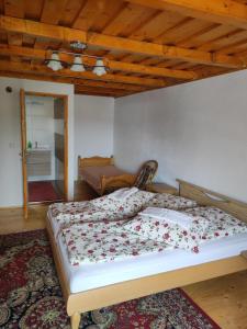 a large bed in a room with a wooden ceiling at Elza Guesthouse in Rimetea