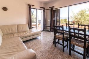 a living room with a couch and a table with chairs at Grifeu 6 Apartamento luminoso con terraza y vistas in Girona +9 photos