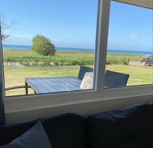 una ventana con vistas a una mesa y sillas en Aa Strand Camping, en Ebberup