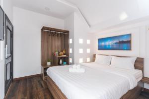 Postel nebo postele na pokoji v ubytování MSing DaLat Hotel