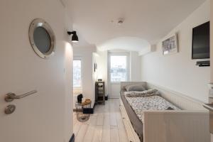 a bedroom with a bed and a mirror on the wall at Sopot, the very heart! in Sopot