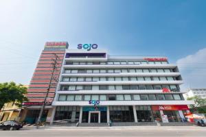a large building with a sign on top of it at SOJO Hotel Viet Tri in Việt Trì