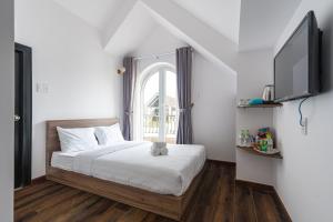 Postel nebo postele na pokoji v ubytování MSing DaLat Hotel