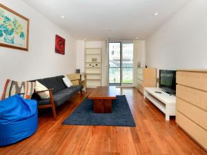 a living room with a couch and a table at Pass the Keys Super Central Spacious 2 Bed Apartment with Parking in Cardiff