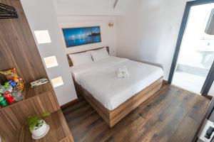Postel nebo postele na pokoji v ubytování MSing DaLat Hotel