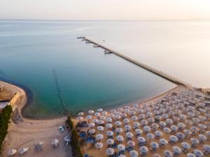 a beach filled with lots of beach chairs and umbrellas at AMC Royal Hotel & Spa in Hurghada