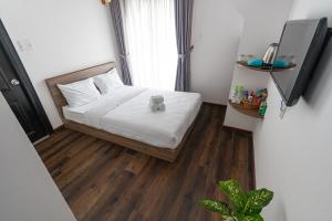Postel nebo postele na pokoji v ubytování MSing DaLat Hotel