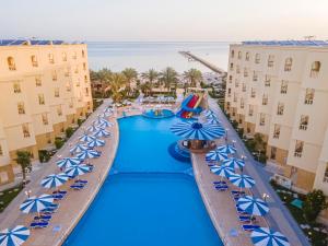 an overhead view of a resort pool with blue umbrellas at AMC Royal Hotel & Spa in Hurghada