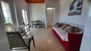 a living room with a couch and a table at MOSXONAS House in Áyioi Asómatoi