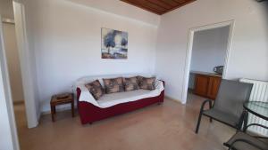 a bedroom with a bed and a table and a chair at MOSXONAS House in Áyioi Asómatoi