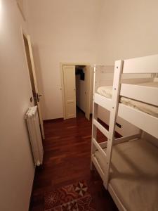 a small room with a bunk bed and a hallway at Dimora Marila in Noci