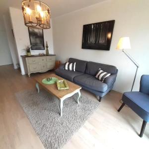 a living room with a couch and a coffee table at Ferienwohnung Country in Born