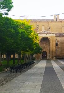 a courtyard of a building with chairs and trees at El Rincón de Pilar in Casalarreina