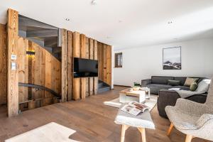 a living room with a couch and a tv at Chalet Badi Argentière Chamonix - by EMERALD STAY in Chamonix