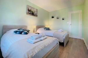 1 dormitorio con 2 camas y toallas. en Entre Vignes et Détente, en Mareuil-le-Port