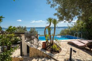 a villa with a pool and a view of the water at Holiday Residence Mirabella in Lokva Rogoznica
