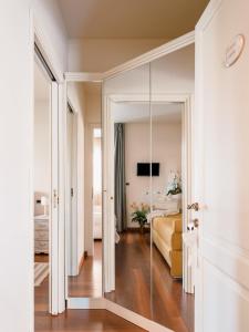a large mirror in a room with a bedroom at Villa Diletta b&b in Forte dei Marmi