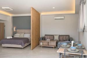 a bedroom with a bed and a couch and a table at Beach Luxury Suite in Tsilivi
