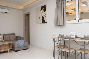 a living room with a couch and a table at Beach Luxury Suite in Tsilivi