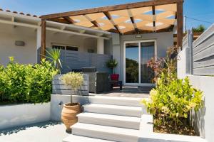 a home with a patio with a pergola at Beach Luxury Suite in Tsilivi