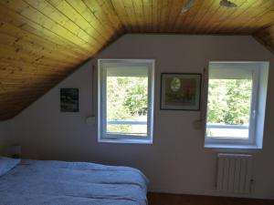 a bedroom with two windows and a bed at Duplex 4 personnes La Calypso in Blangy-sur-Bresle