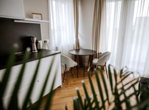 a kitchen with a table and chairs in a room at B Residence - Boutique Apartments Ljubljana - Private Parking in Ljubljana