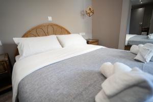 a bedroom with a large bed with towels on it at Parthenis Riviera Hotel in Athens