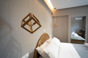 a bedroom with a bed and a mirror on the wall at Parthenis Riviera Hotel in Athens