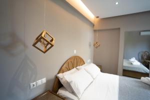 a bedroom with a bed with white sheets at Parthenis Riviera Hotel in Athens