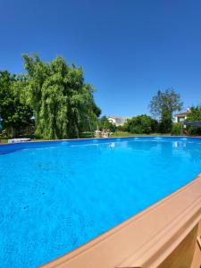 a large swimming pool with blue water at The Studio, in Saint-Rabier