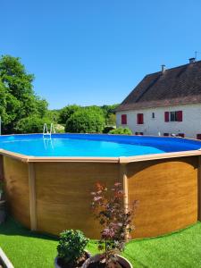 a swimming pool in a backyard with a wooden deck at The Studio, in Saint-Rabier