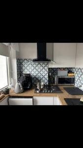 a kitchen with white cabinets and a stove top oven at Krasickiego 12 Gdynia Centrum in Gdynia +9 photos